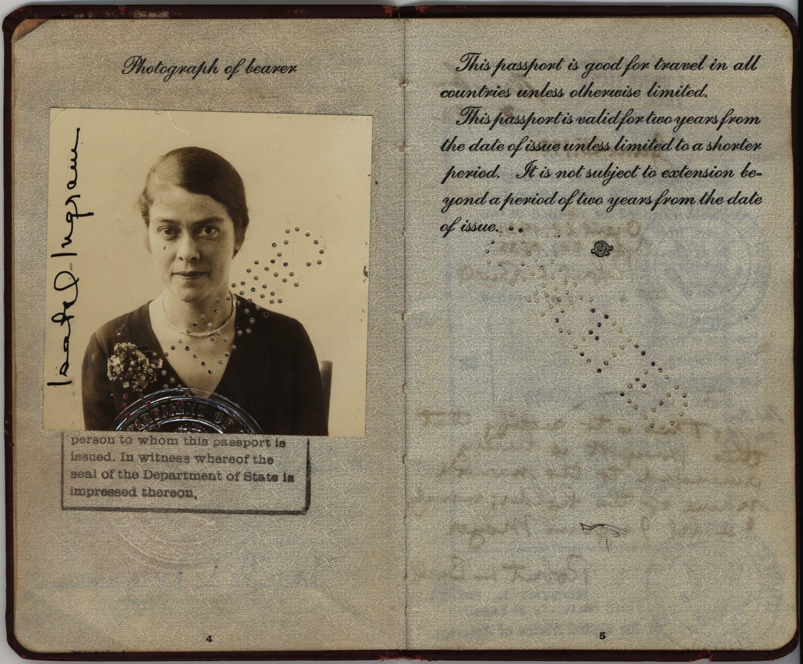 An old passport with yellowed pages and a photo attached to it